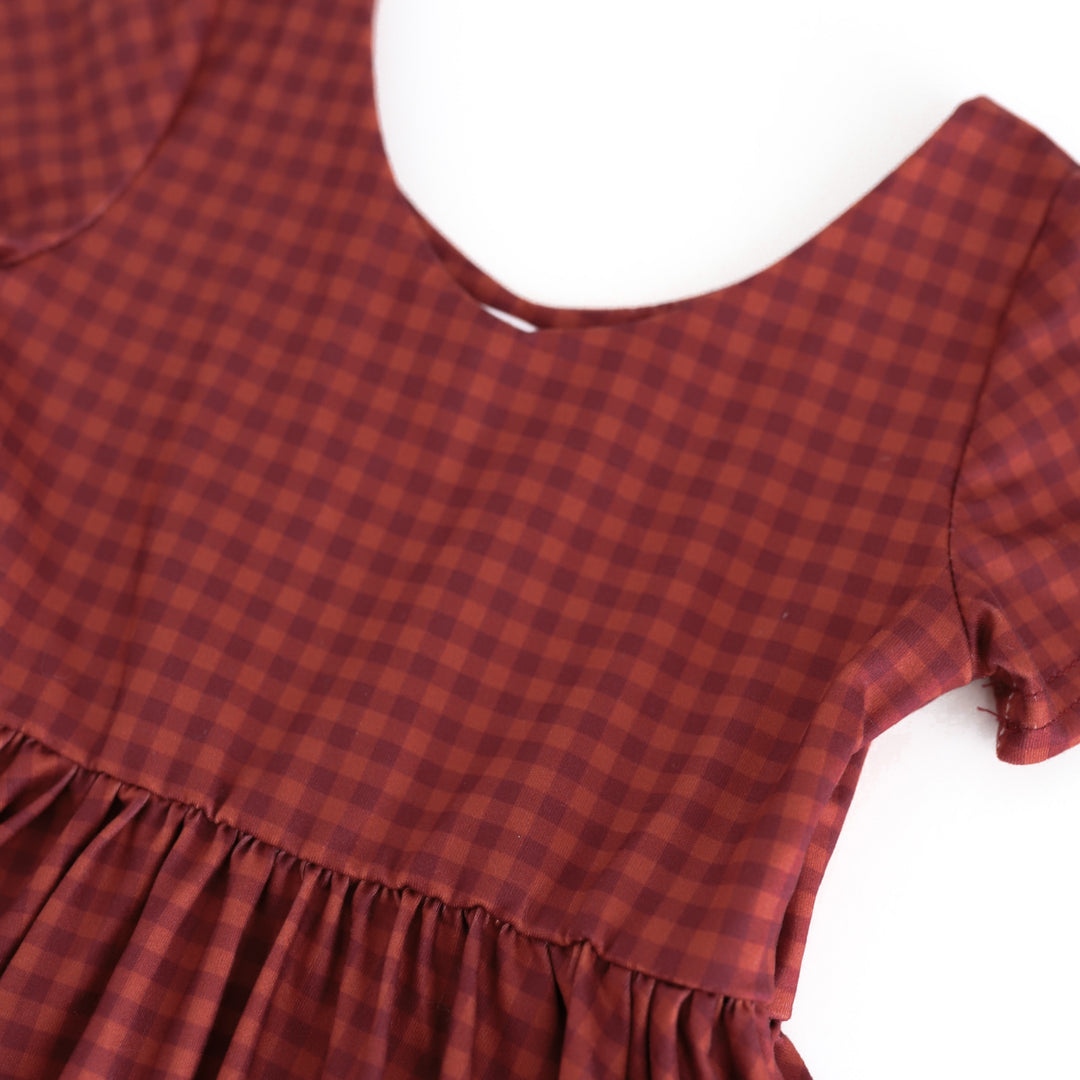 closeup of v-neck bodice on rust gingham fall twirl dress