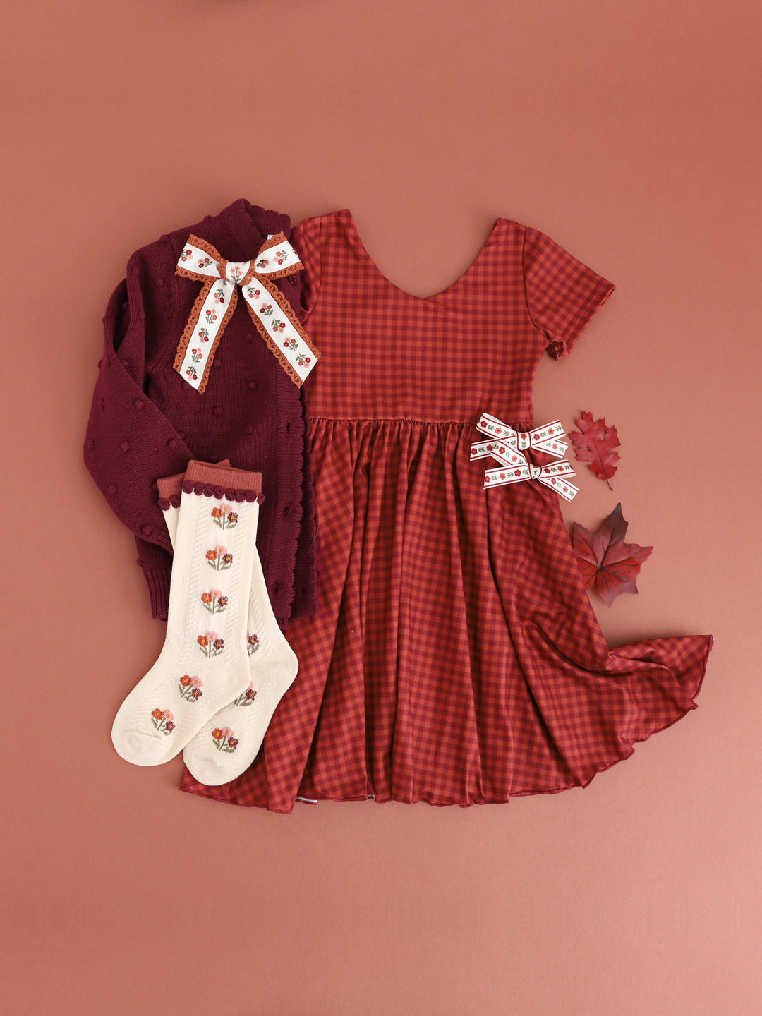 girls' rust gingham v-neck twirl dress with matching cream and rust knee socks and hair bows and burgundy cardigan