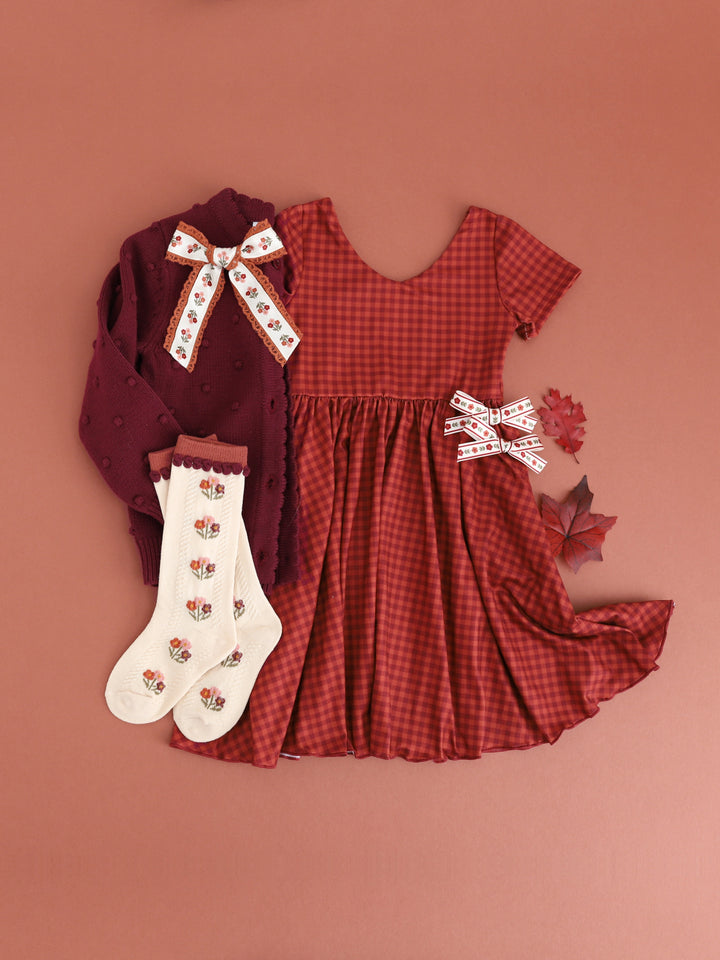 girls' rust gingham v-neck twirl dress with matching cream and rust knee socks and hair bows and burgundy cardigan
