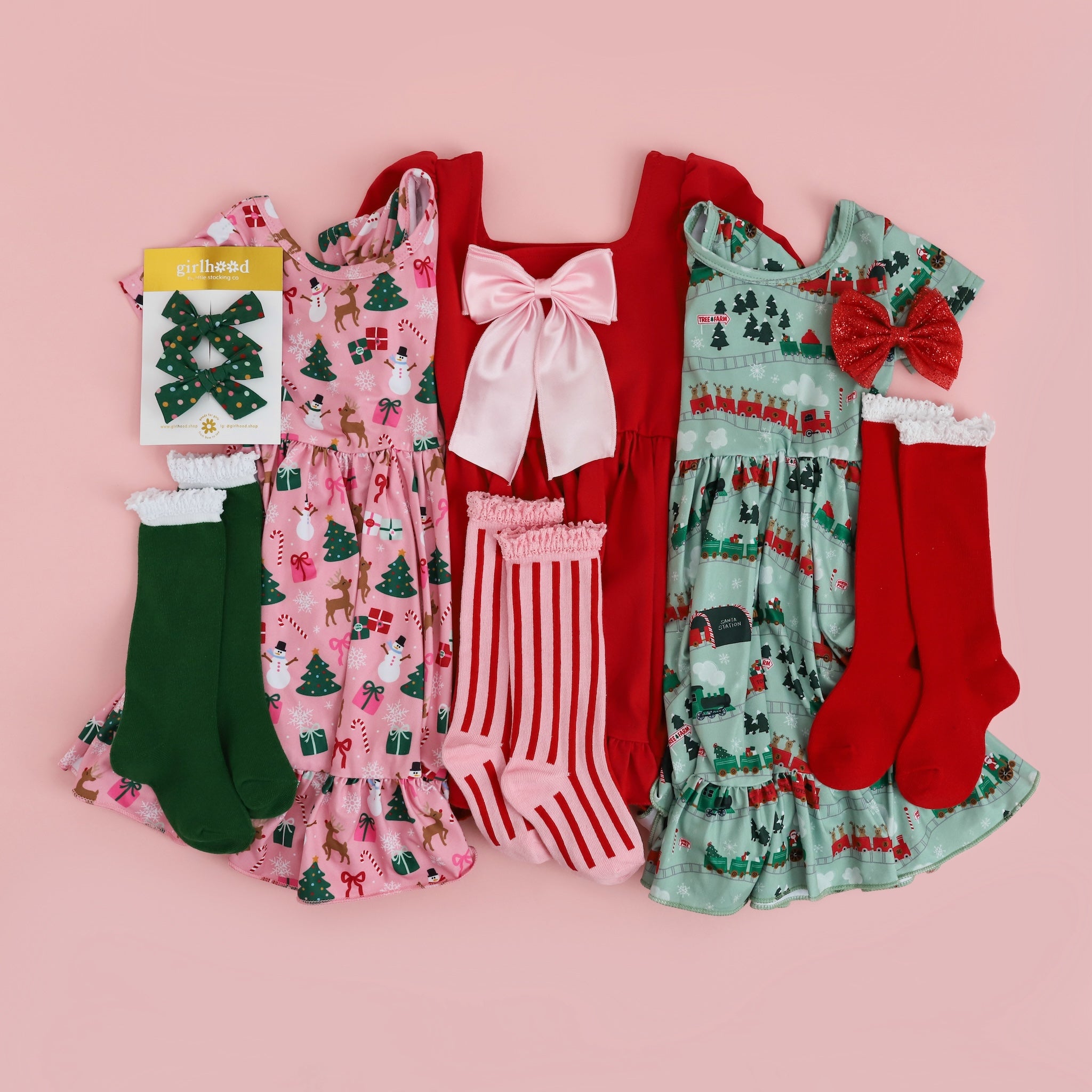 little girls Christmas themed dresses with matching green, red and candy cane striped knee high socks and holiday bows