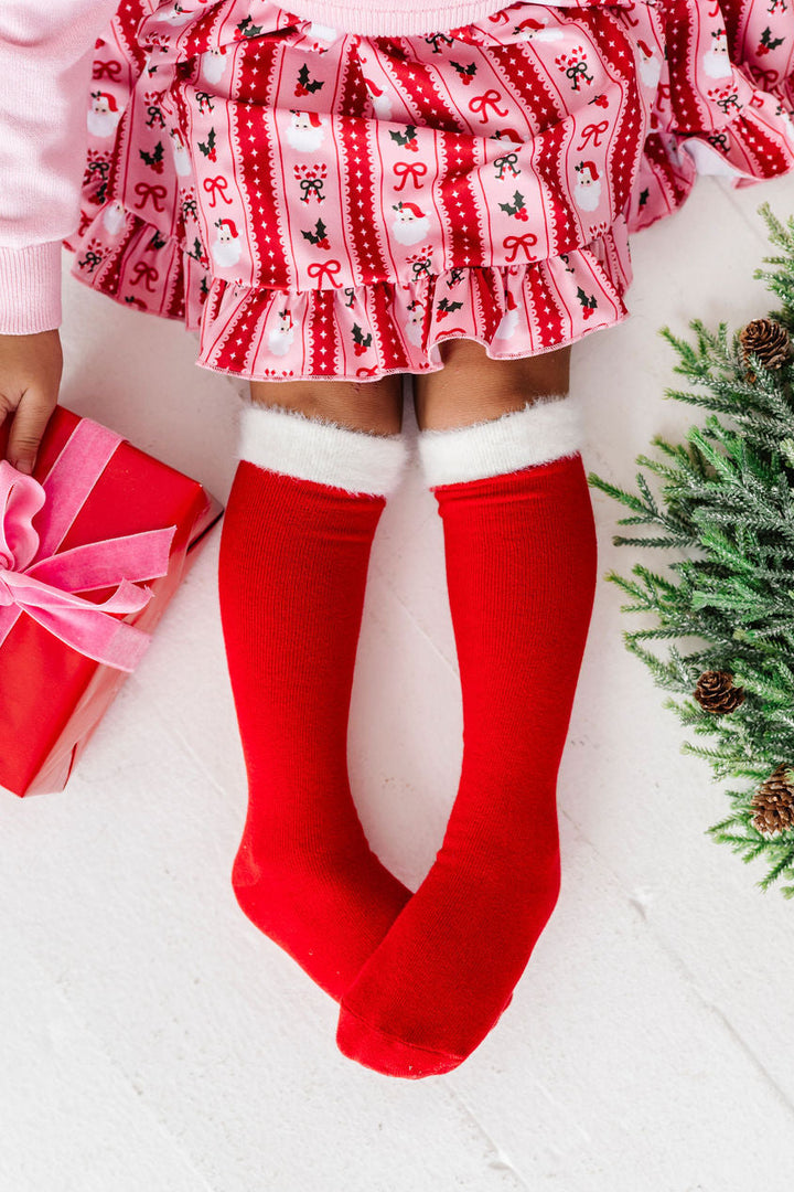 little girl wearing fluffy santa knee high socks