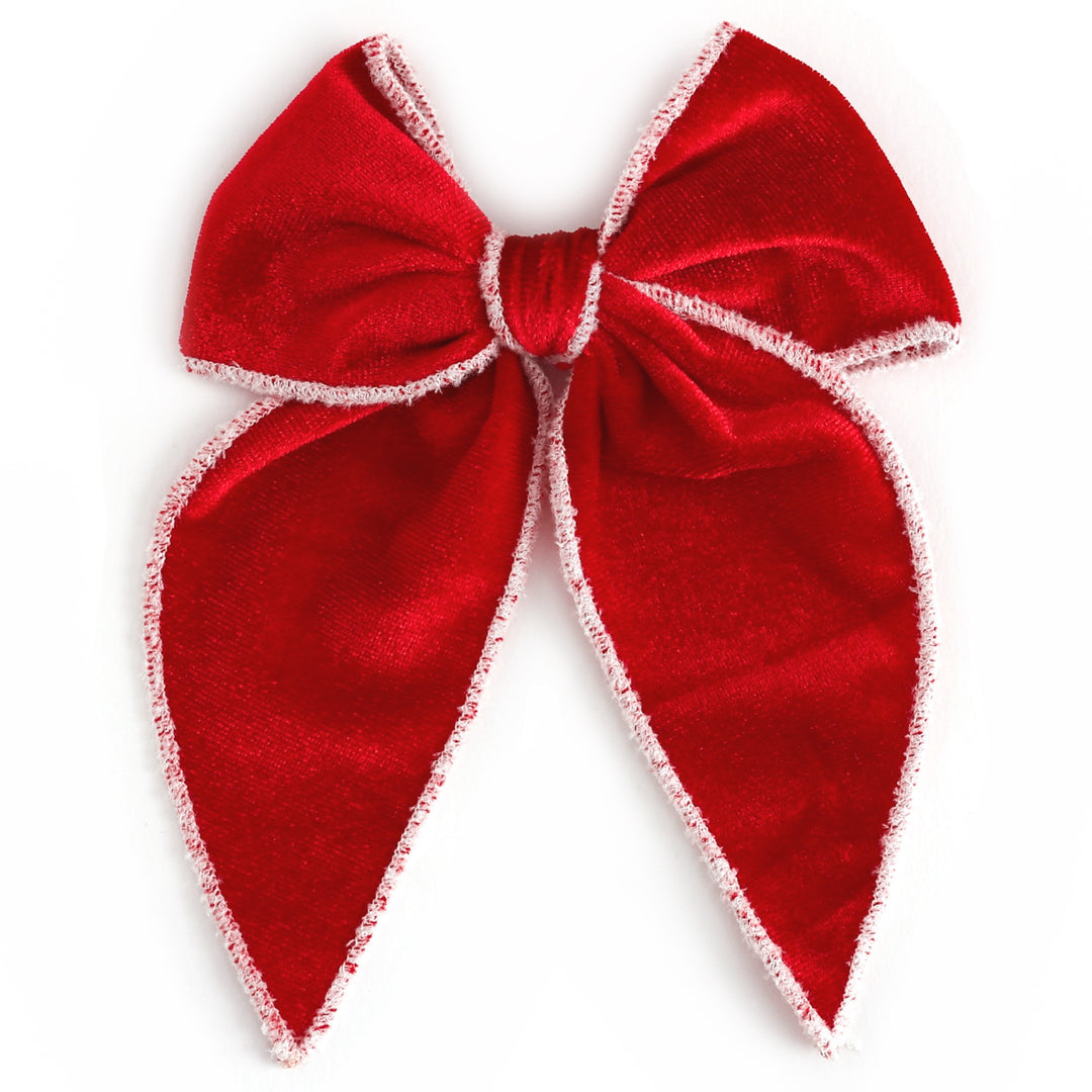 girls' red velvet Christmas bow with white velvet trim on clip