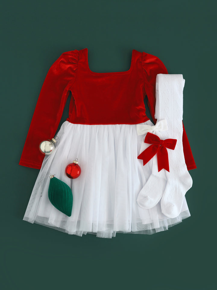 flat lay of Santa baby velvet tutu dress with bright red velvet bodice and white tulle skirt paired with white cable knit tights and matching velvet hair bows