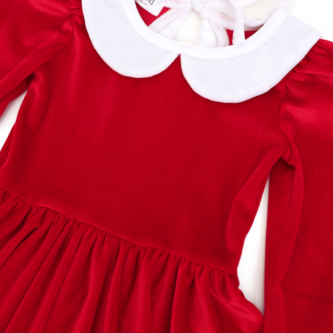 closeup of red velvet Christmas twirl dress with white velvet collar