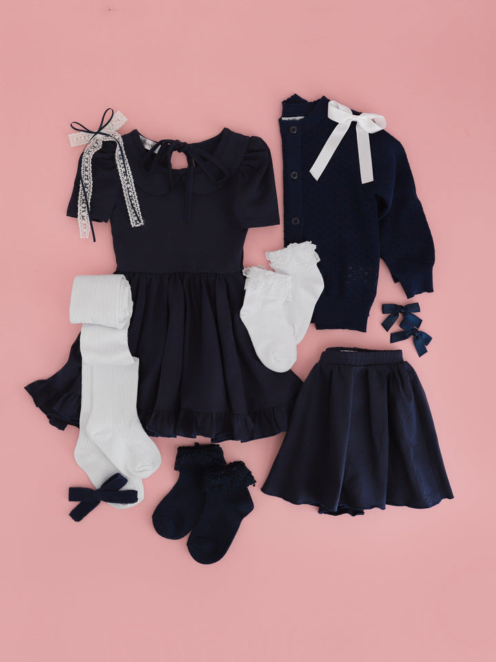 girls' uniform dress, skort, sweater, socks and bows in navy and white for back to school