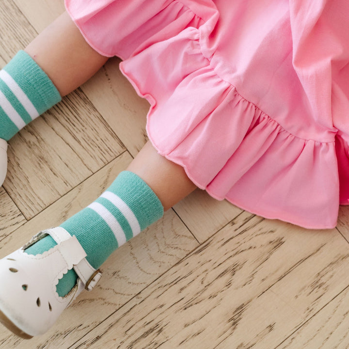 sea glass and white striped midi socks on little girl in pink ruffle twirl dress