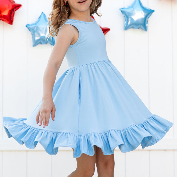twirling little girl with ruffler hemmed light blue cotton 4th of july summer dress