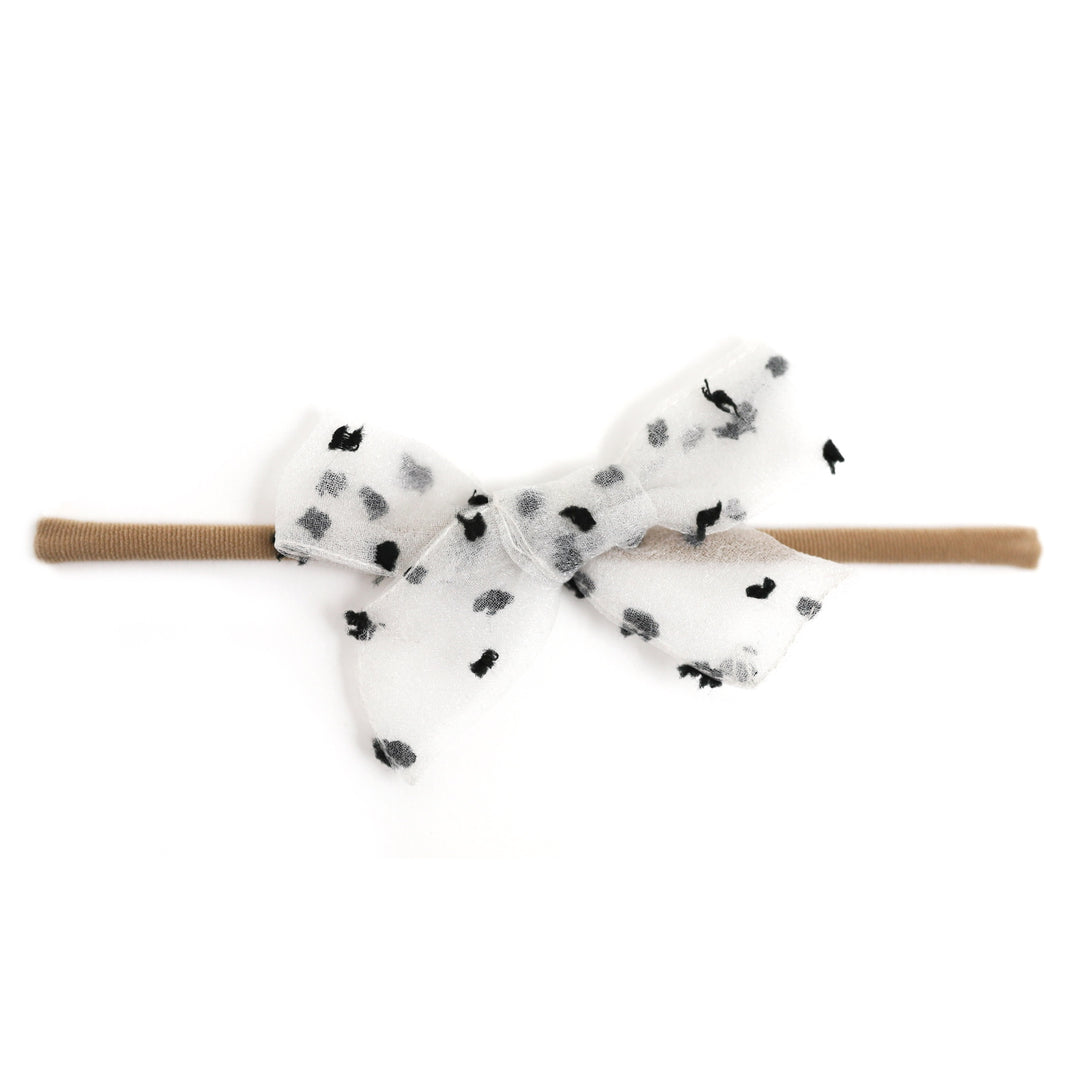 sheer white baby bow with black dots