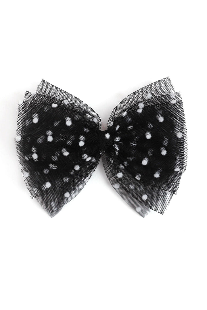 A black tulle bow decorated with small white polka dots, photographed against a solid white background.