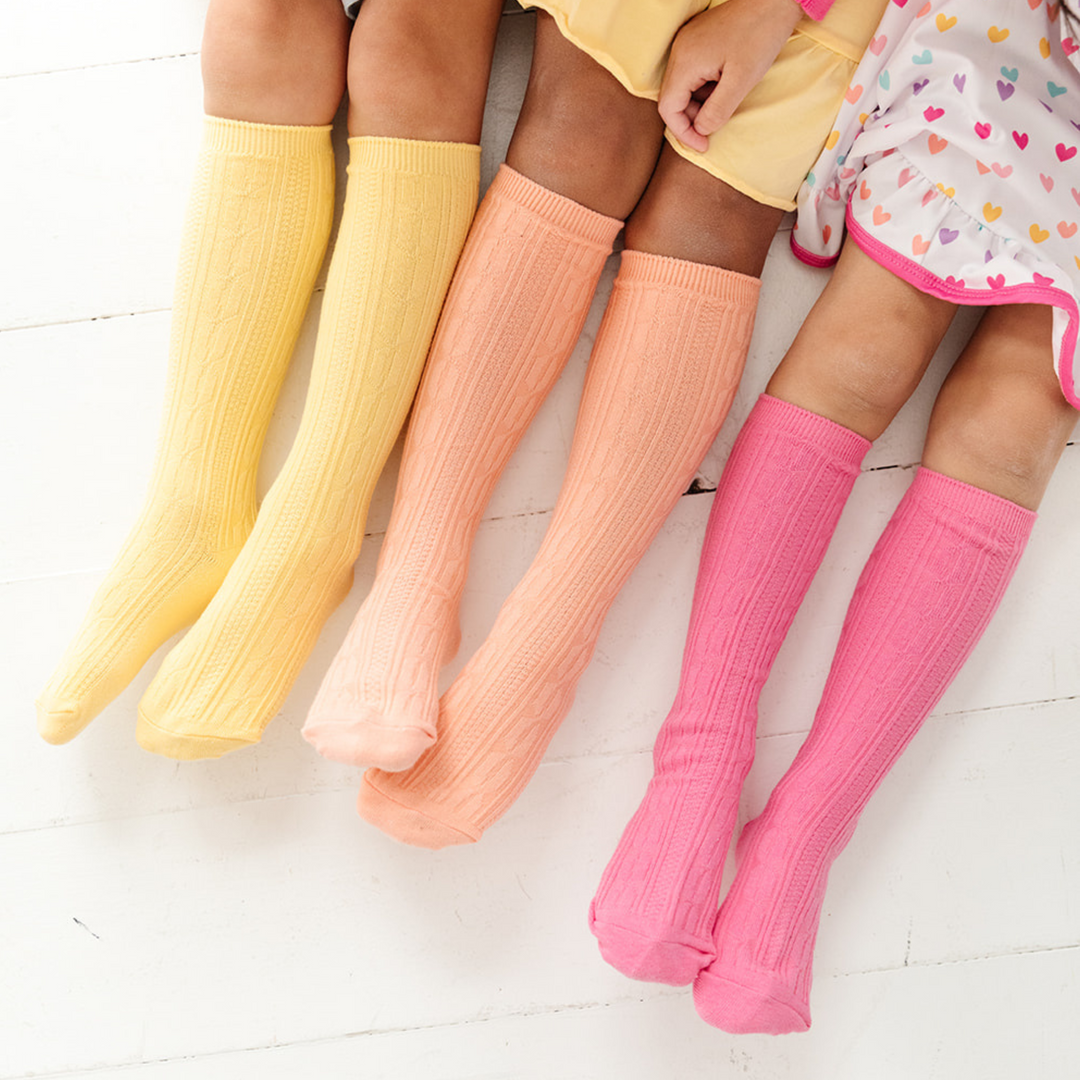 girls cable knit knee high socks in yellow, peach and pink