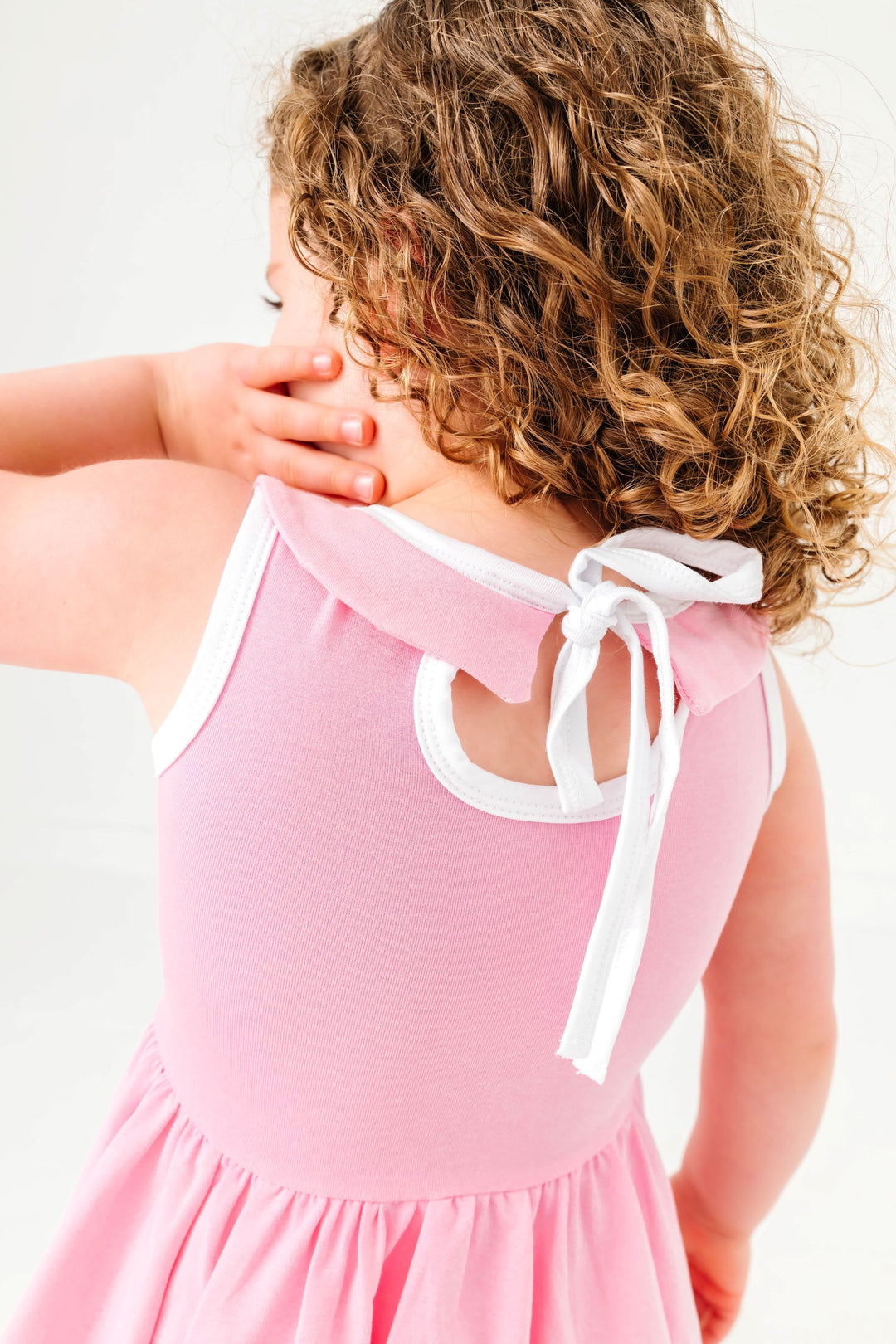 closeup of keyhole tie back on light pink twirl dress with collar