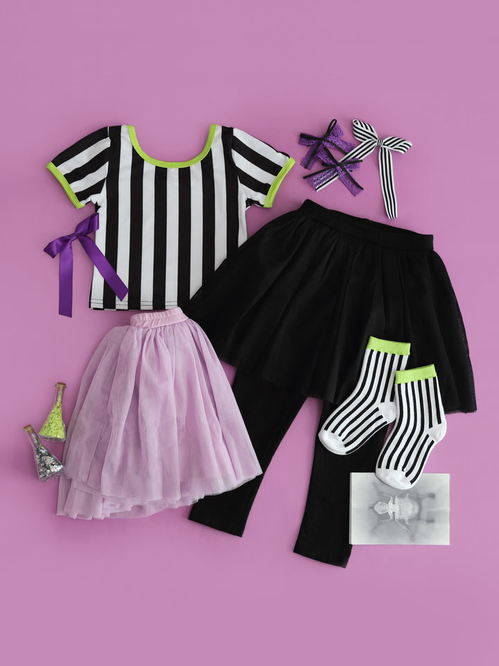 girls' Beetlejuice inspired outfit mix and match with black and white striped fitted top, lavender tutu skort, black tutu leggings, and matching purple and striped accessories