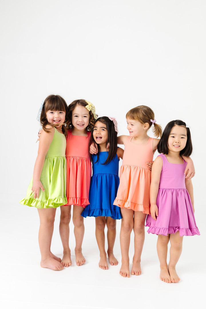 five girls in square neck sleeveless twirl dresses in bright summer shades