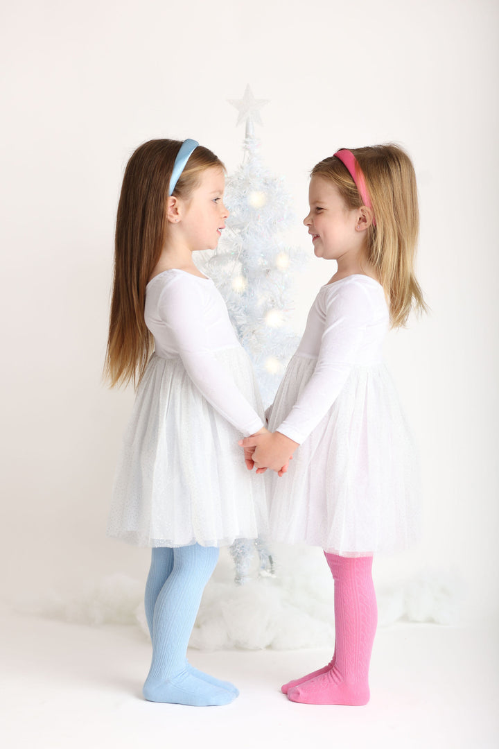 little girls in snowy white princess dresses with matching pink and blue  headbands and tight for Christmas