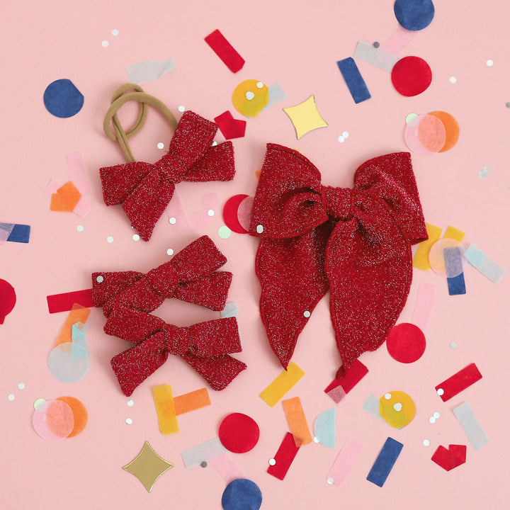 collection of sparkly red hair bows 