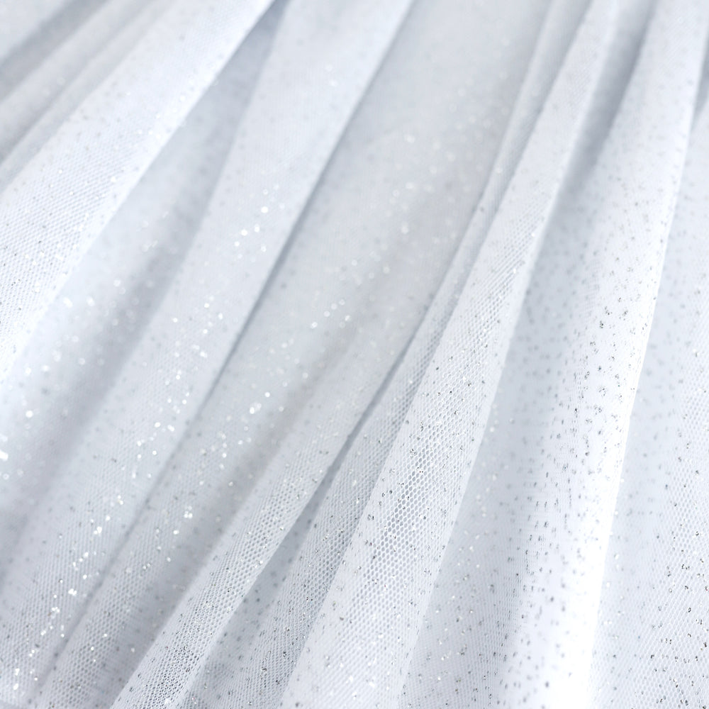 closeup of girls' white tulle skirt with silver sparkles