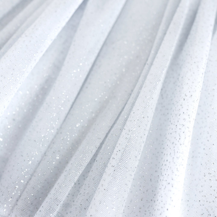 closeup of girls' white tulle skirt with silver sparkles