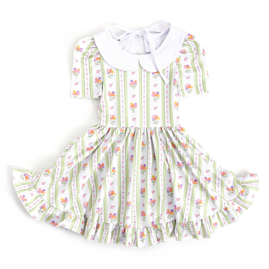 little girls spring and easter dress with spring floral wallpaper design