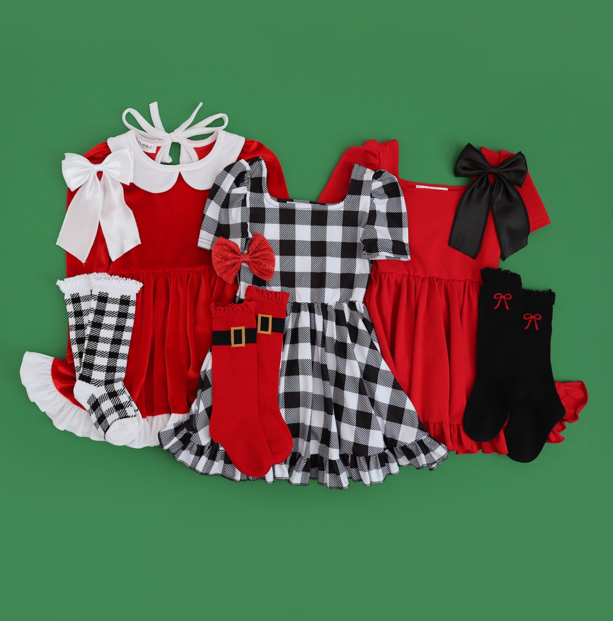 Santa inspired collection of three Christmas dresses for girls with red, white and black color palette