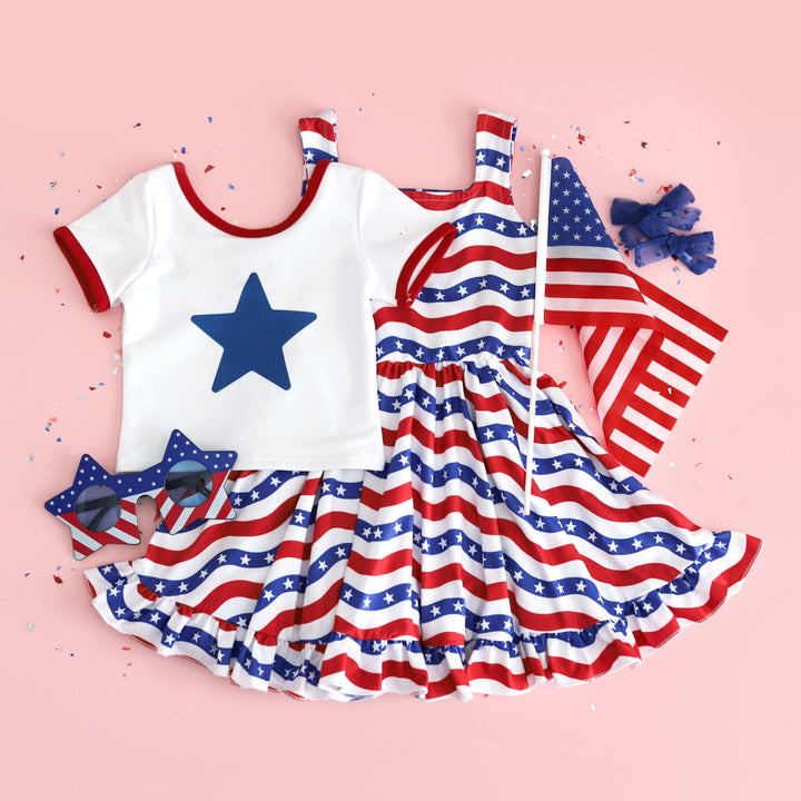 girls white t-shirt with red binding and blue sublimated star design and stars and stripes sleeveless twirl dress for 4th of July