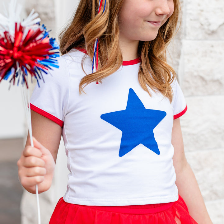 girl in white t-shirt with single blue star and red binding for 4th of July