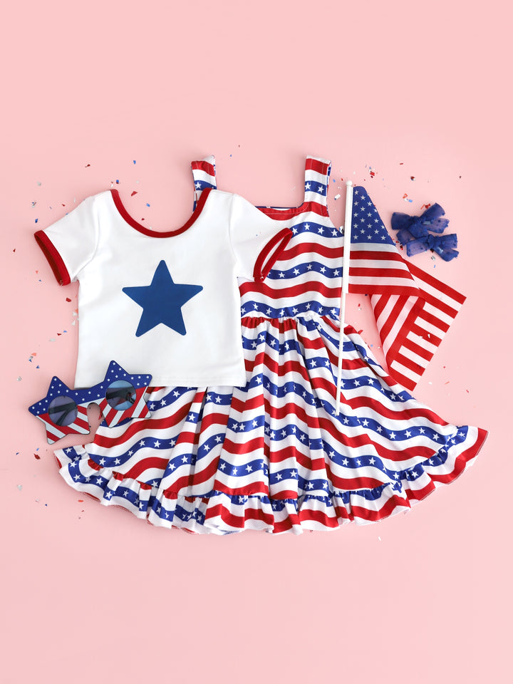 flatlay of girls red white and blue stars and stripes sleeveless dress and star ringer tee for fourth of july