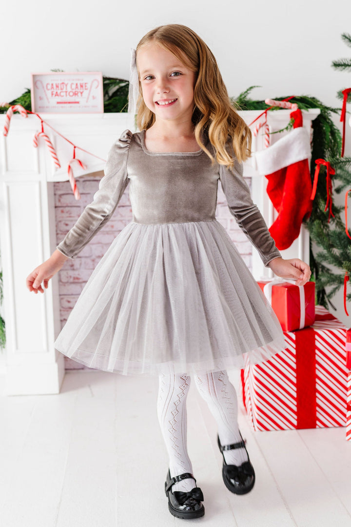 girl in christmas scene wearing silver fancy tutu dress