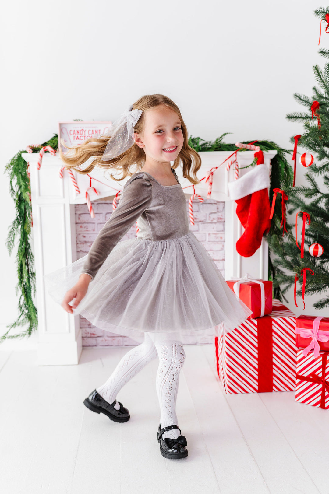 girl twirling in silver fancy christmas dress