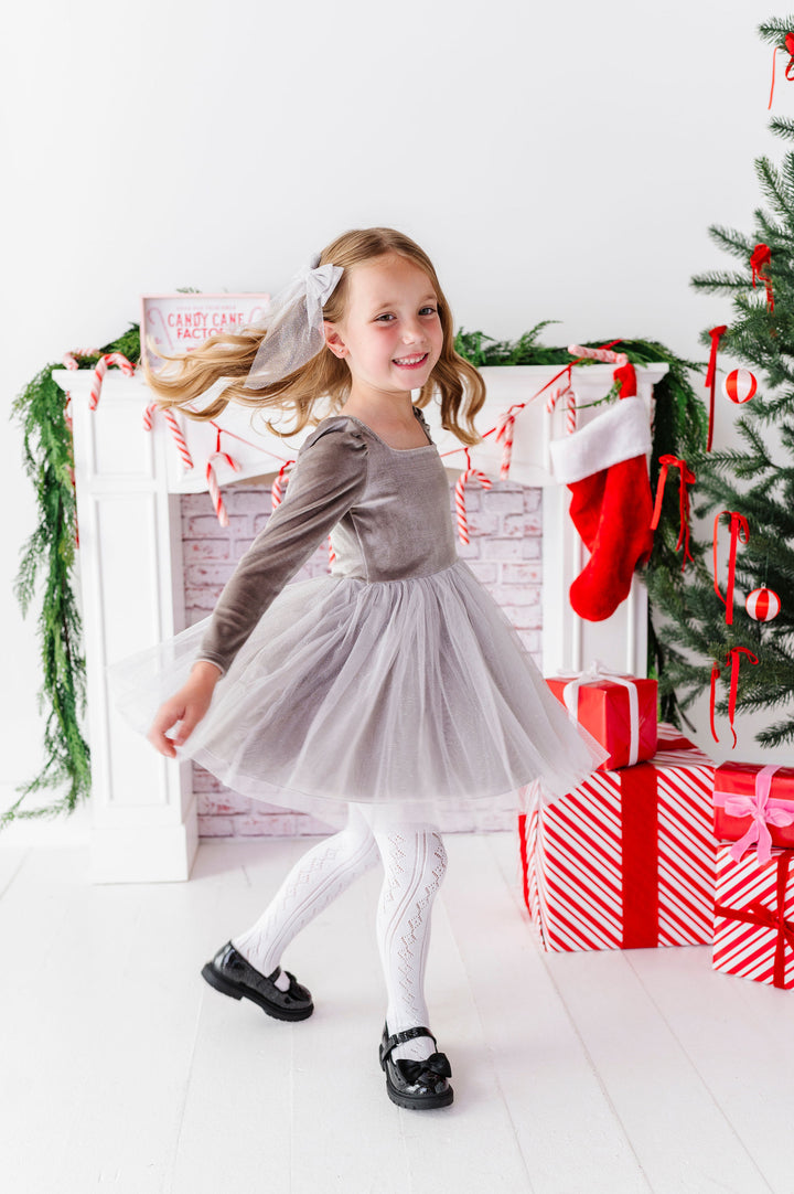 girl twirling in silver fancy christmas dress