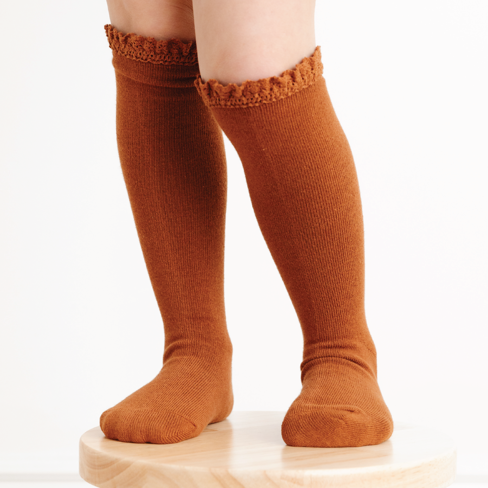 girl wearing sugar almond brown lace top knee high socks