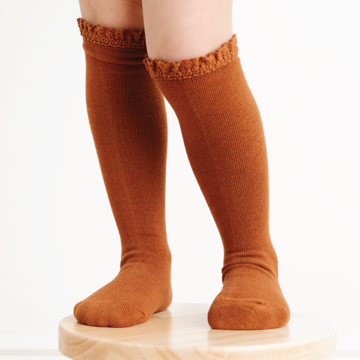 girl wearing sugar almond brown lace top knee high socks