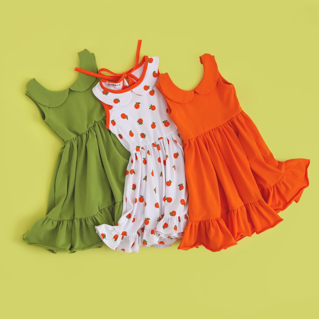 collection of girls' summer tank dresses in lime green, bright orange and cute orange design