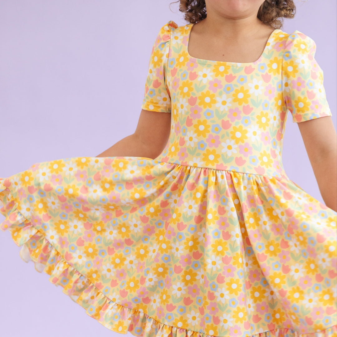 detail photo of little girl's yellow floral dress