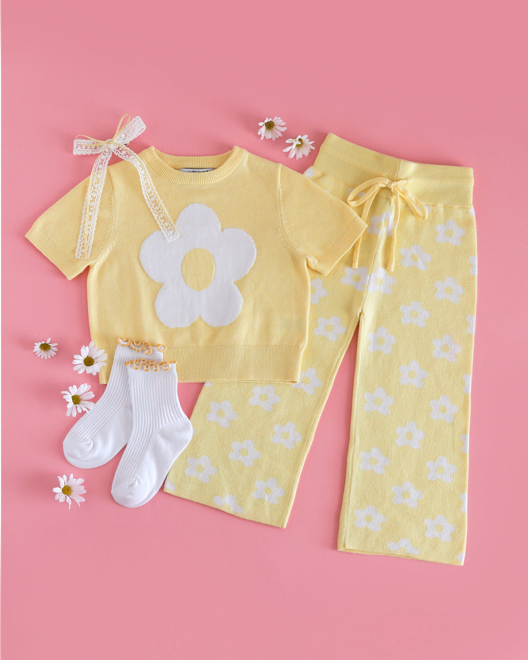 girls' spring sweater set with pastel yellow short sleeve flower knit top and matching yellow sweater pants with white flowers paired with yellow lettuce trim midi socks and matching hair bow