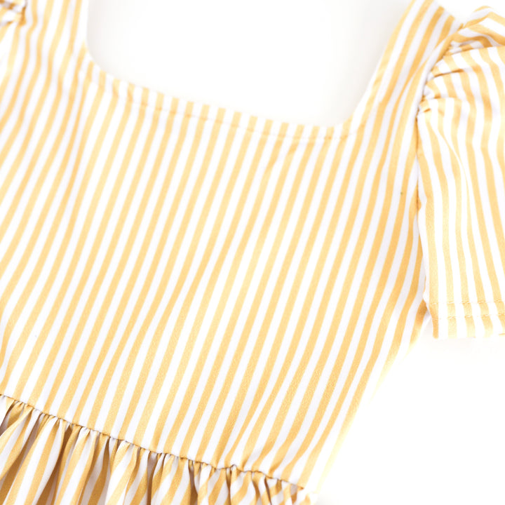 closeup of girls' twirl dress bodice with pastel yellow and white pinstripe print