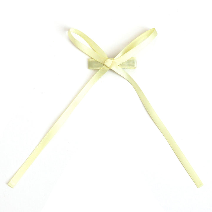 girls' dainty pastel yellow long tail satin ribbon bow on clip for spring and easter