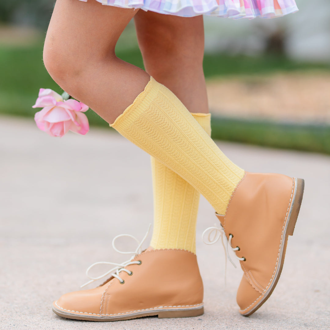 girl holding pink rose in pastel yellow scalloped knee socks 