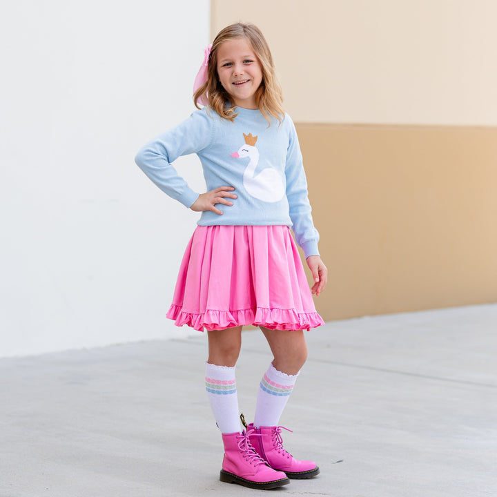 girl in blue swan princess knit pullover with taffy pink twirl dress and matching pastel knee highs