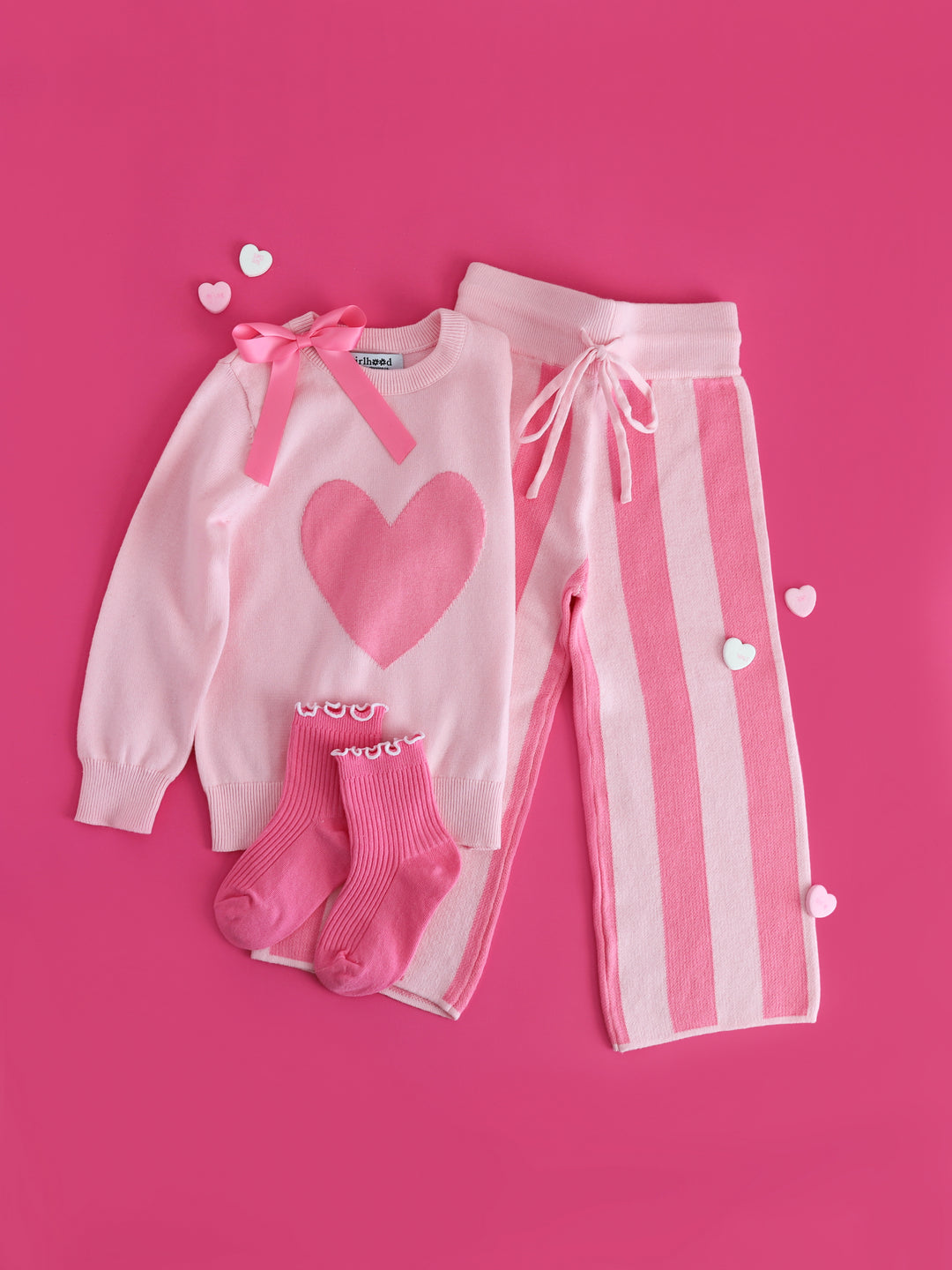 girls two tone pink heart sweater and striped sweater pants for Valentine's day with matching link lettuce trim midi socks and satin bow