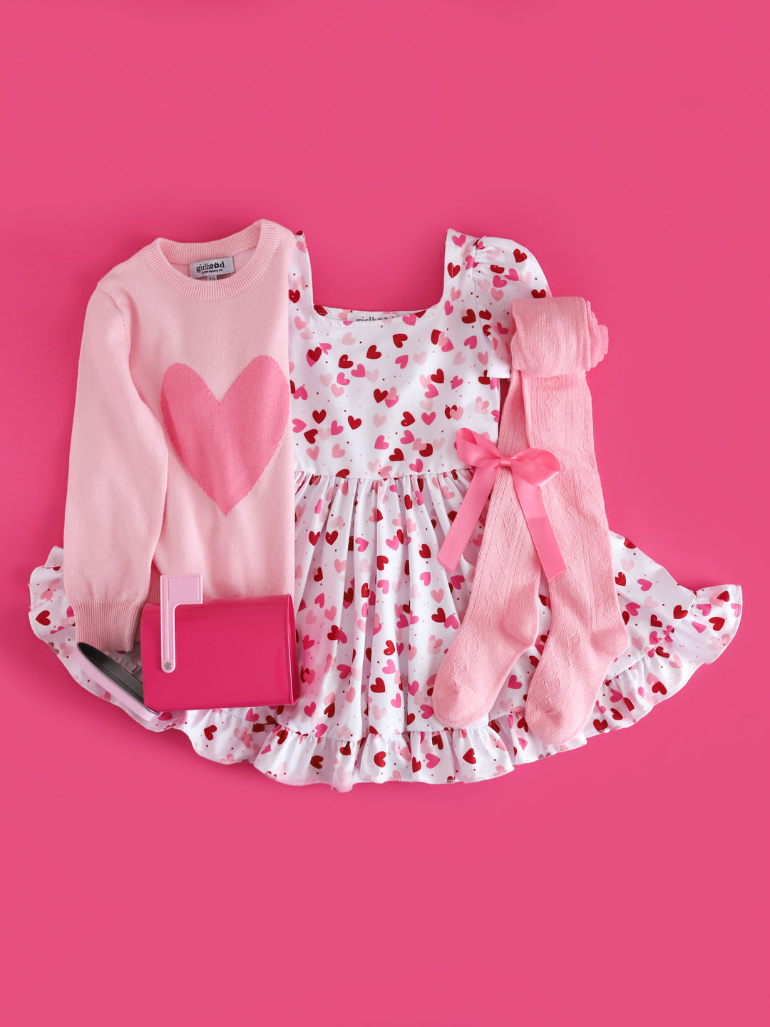 girls two tone pink heart sweater, white twirl dress with scattered heart print, light pink open knit tights and matching pink satin bow for Valentines day