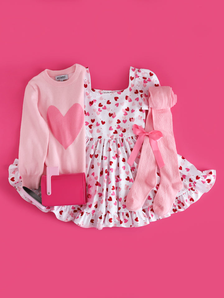 girls two tone pink heart sweater, white twirl dress with scattered heart print, light pink open knit tights and matching pink satin bow for Valentines day