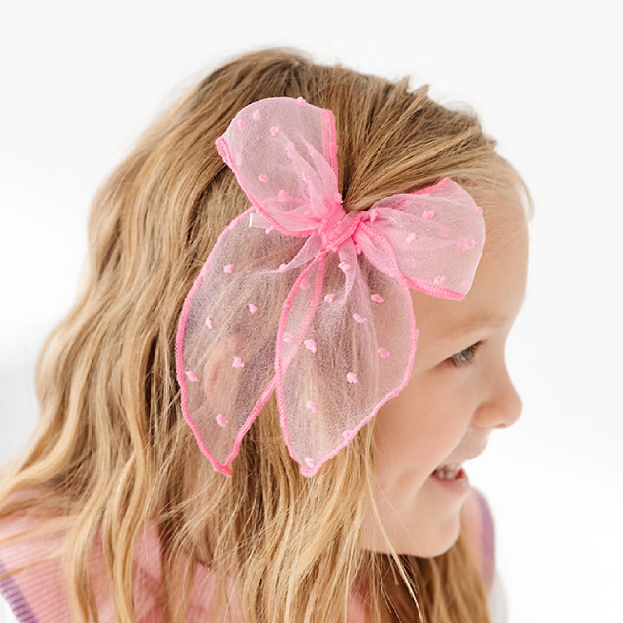 girl with taffy pink sheer dot hair bow 