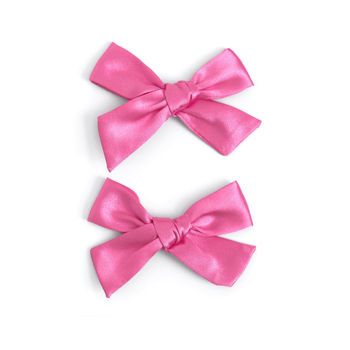 little girl in pink satin pigtail bows on clips for spring