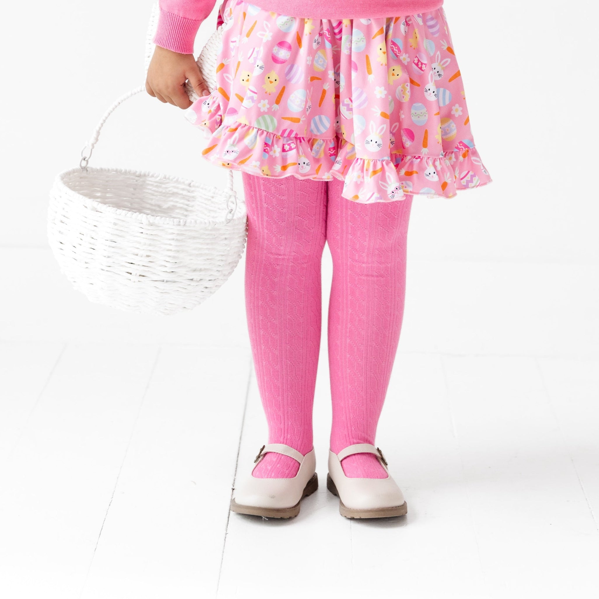 girl wearing hot pink cable knit tights with easter dress