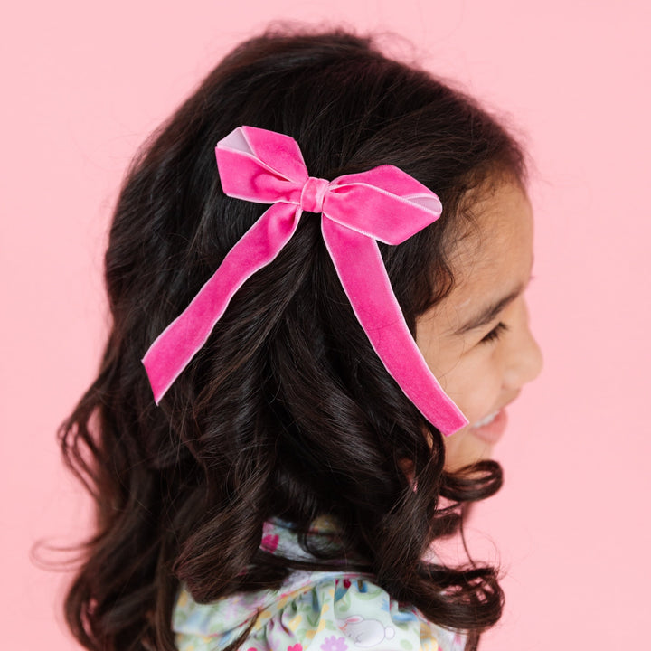 girl wearing taffy pink velvet ribbon bow