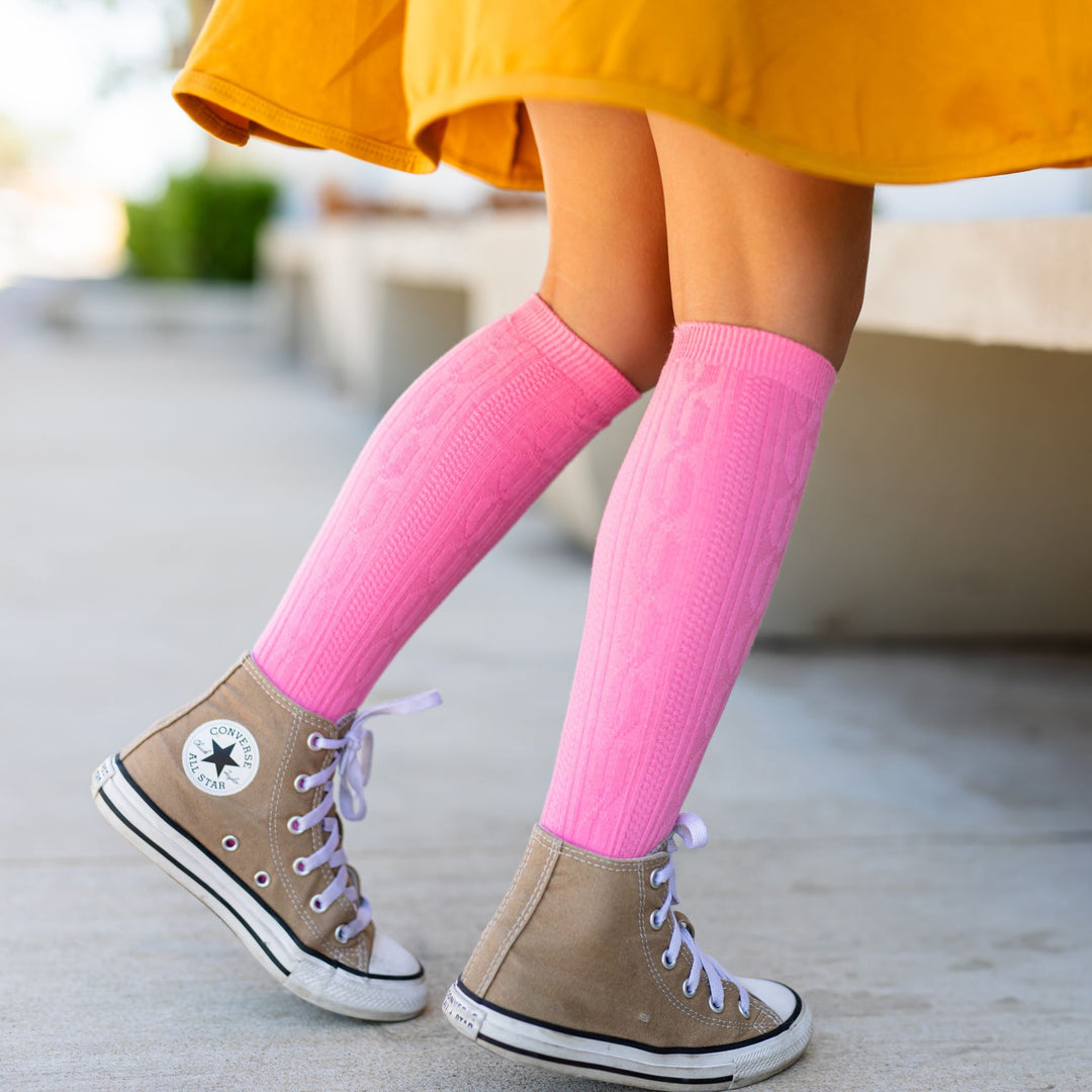 girls cable knit tights in pink paired with high tops and mustard yellow twirl dress