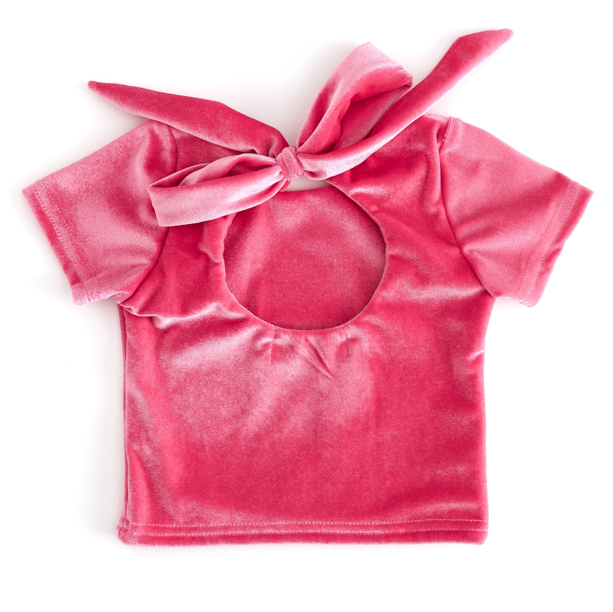 back view of girls pink velvet top with keyhole opening and large tied bow closure 