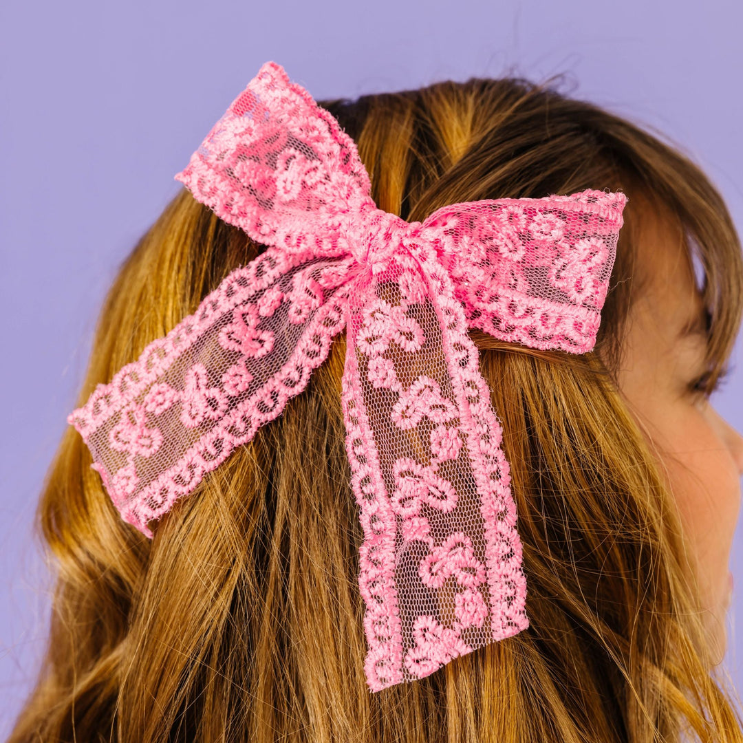 girl with pink lace hair bow on alligator clip