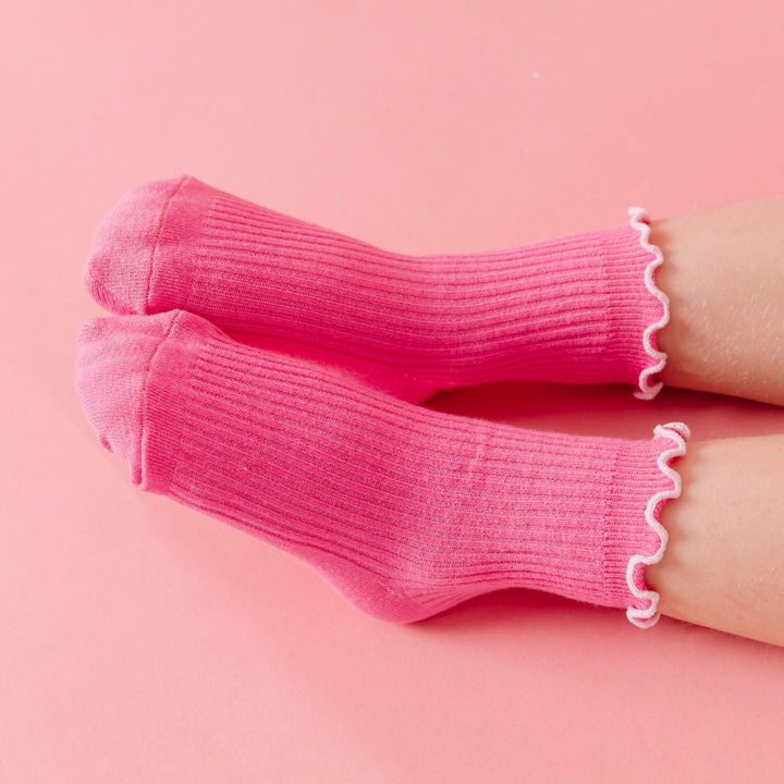 closeup of girl in pink ribbed midi socks with white lettuce trim