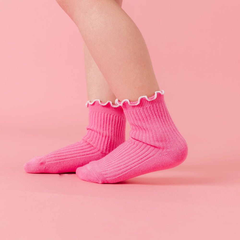 little girl in pink ribbed angle socks with white lettuce trim